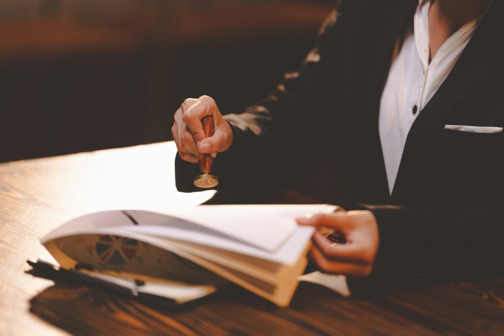 businesswoman person's hand stamping with approved stamp on certificate document public paper